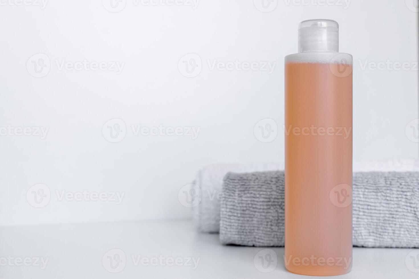 Sleek bathroom essentials with shampoo and body lotion on soft towels in a tranquil setting photo