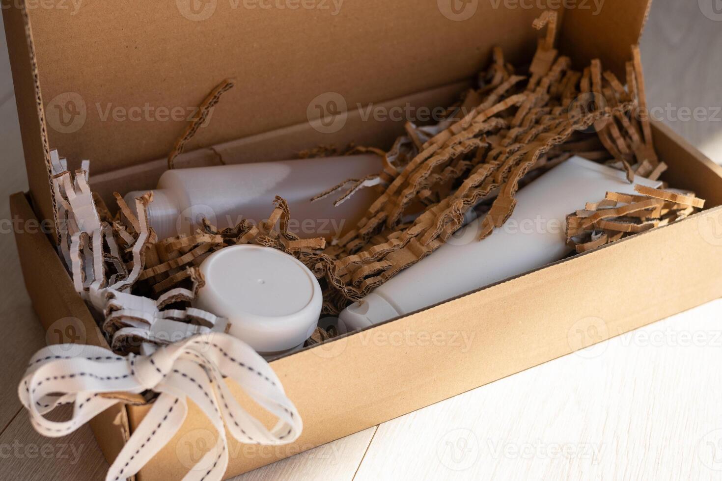 Eco-friendly packaging with personal care products in a cardboard box on a light floor photo