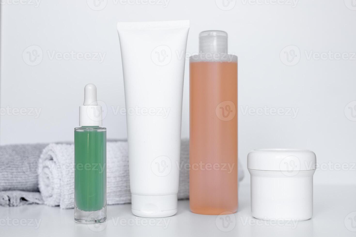 Refreshing skincare products arranged neatly on a white background with towels for self-care routine photo