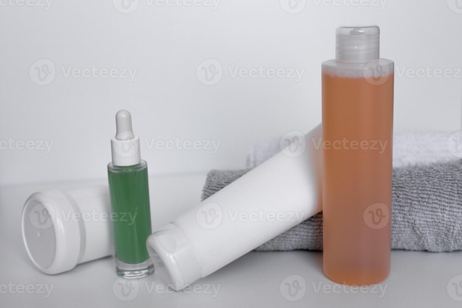 Refreshing skincare products arranged neatly on a white background with towels for self-care routine photo