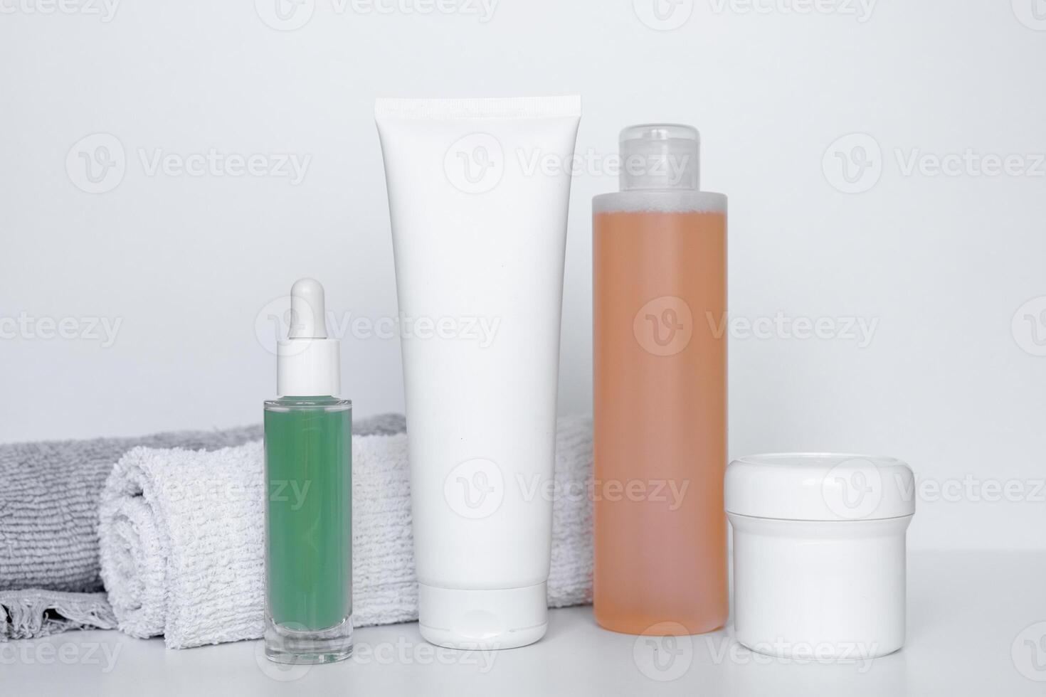 Refreshing skincare products arranged neatly on a white background with towels for self-care routine photo