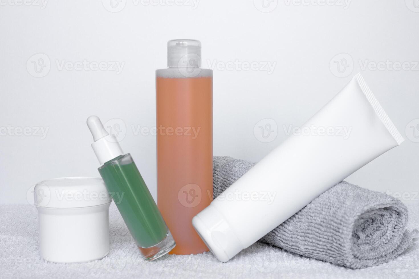Refreshing skincare products arranged neatly on a white background with towels for self-care routine photo