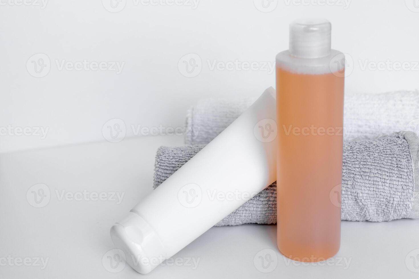 Sleek bathroom essentials with shampoo and body lotion on soft towels in a tranquil setting photo
