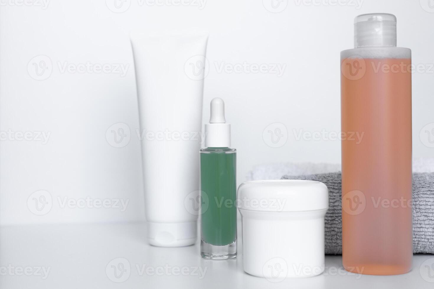 Refreshing skincare products arranged neatly on a white background with towels for self-care routine photo