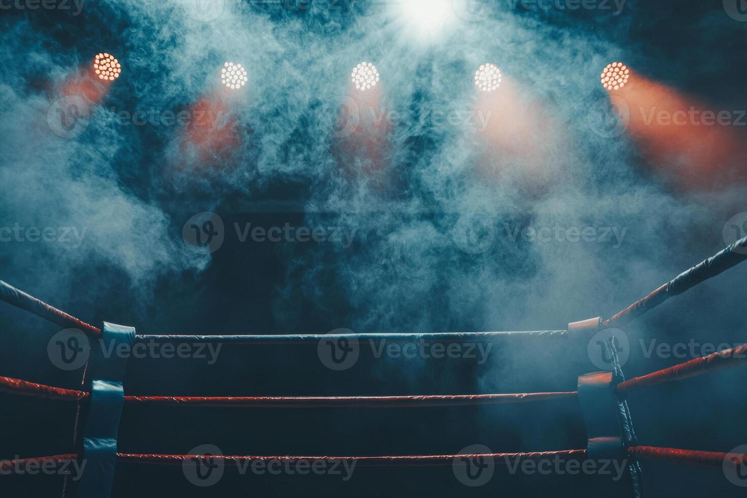 boxing ring is set under low lighting with spotlights casting beams and smoke swirling around the ropes enhancing the anticipation of the upcoming fight. photo