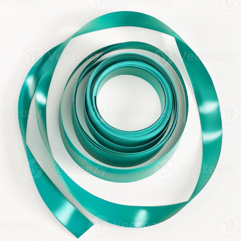 vibrant gymnastic ribbon lays in a spiral formation on a white background highlighting its smooth texture and rich color. Soft shadows create an artistic effect in bright studio light. photo