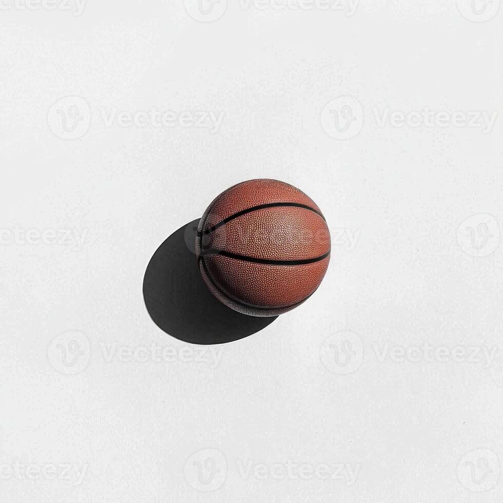 basketball rests on a white surface highlighting its textured surface and distinct black lines. Soft shadows enhance the minimalist aesthetic in midday lighting. photo