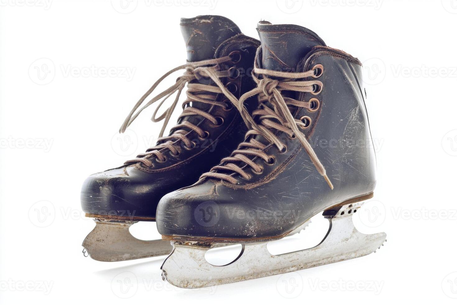 pair of vintage ice skates is featured side by side showcasing their blades and intricate laces against a bright white background enhancing their classic design. photo