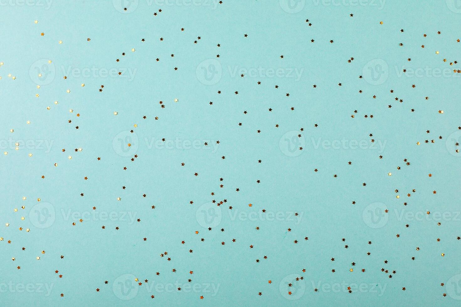 Blue background with little stars glitter confetti. Festive background for text or object, product photo