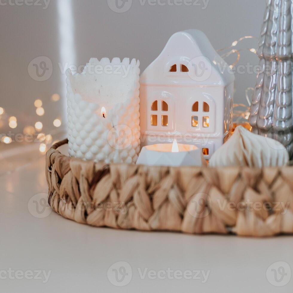 Cozy burning candles and festive decor. Winter mood. Cozy home decor. Festive decoration. Square image crop photo
