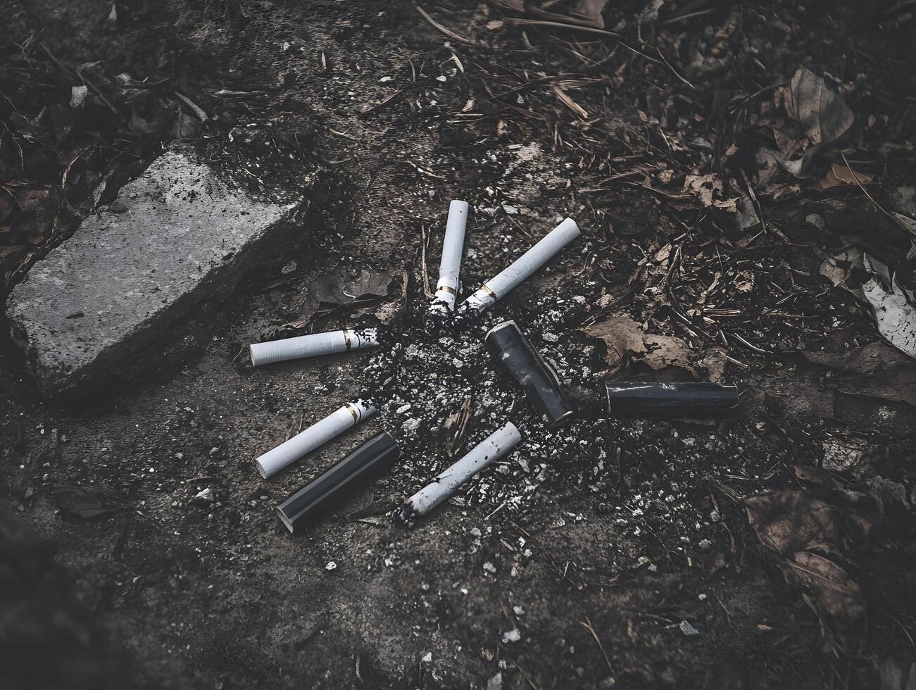Unhealthy habit Tobacco Smoked cigarette ash waste on the ground photo
