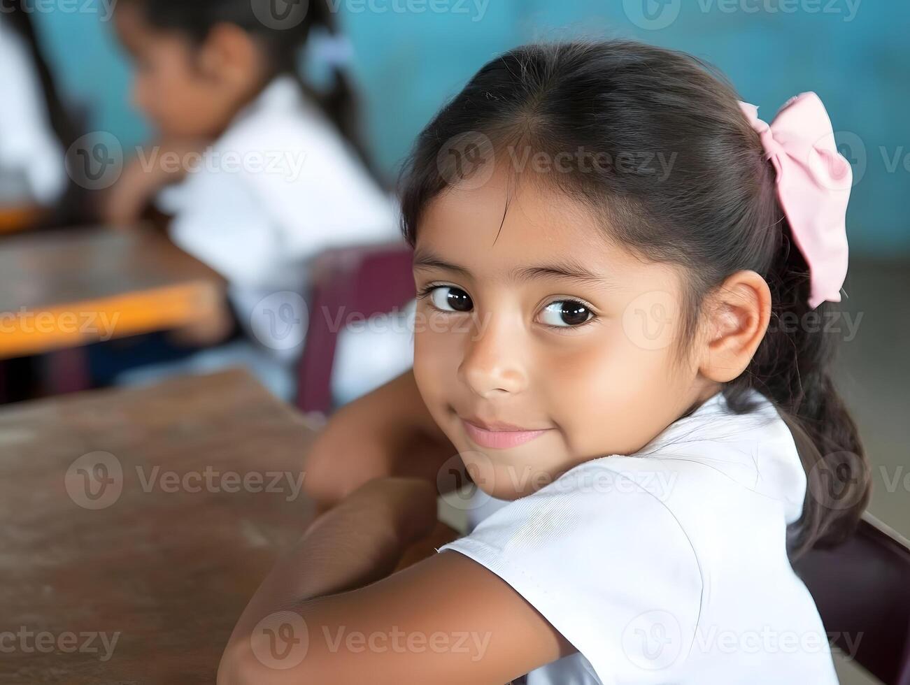 Innocent Cute Hispanic Schoolgirl child portrait. A Girl is learning in School photo