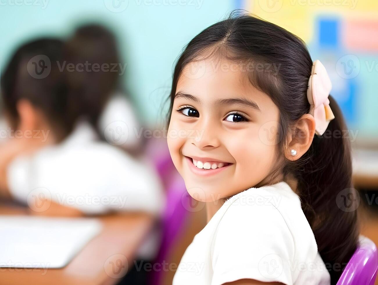 Innocent Adorable Hispanic Schoolgirl child portrait. A Girl is learning in School photo