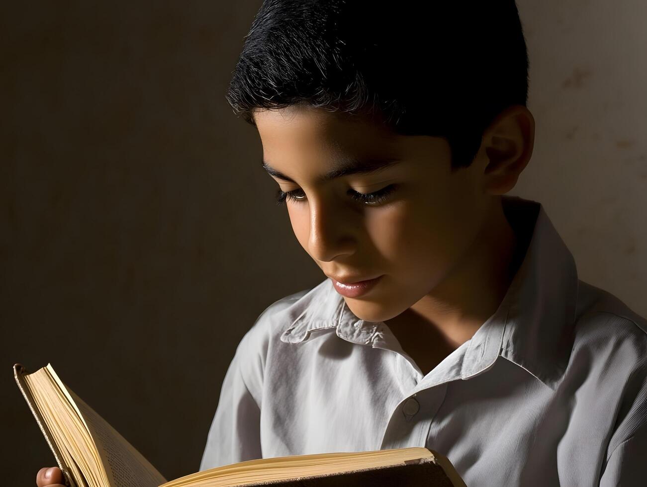 Learning Hispanic schoolboy reading a book in School for Education photo
