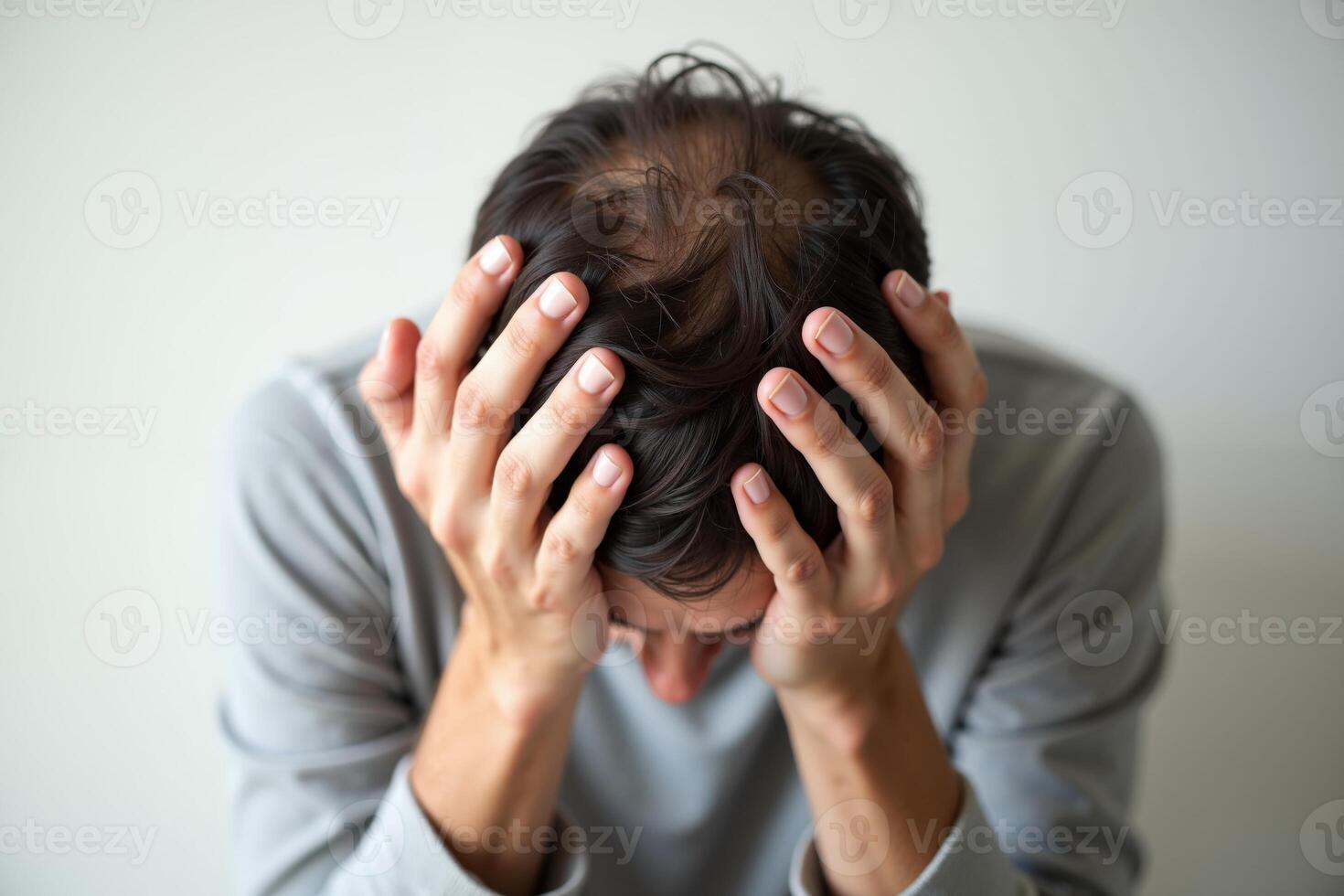 close up of person head stressed about hair problem photo