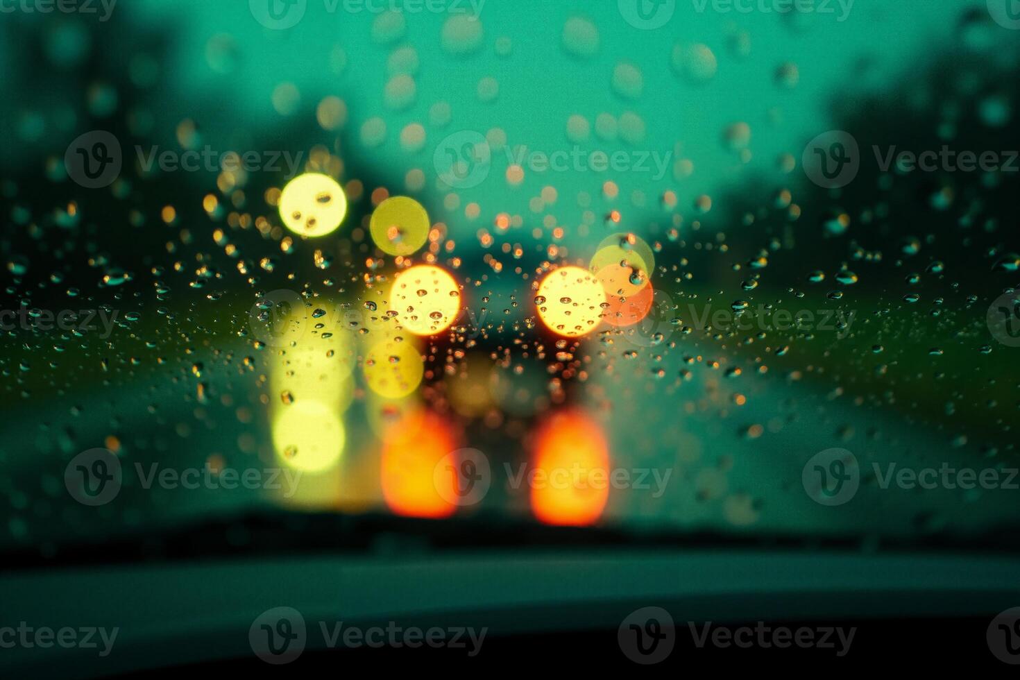 windscreen of car with rain drop water at night photo