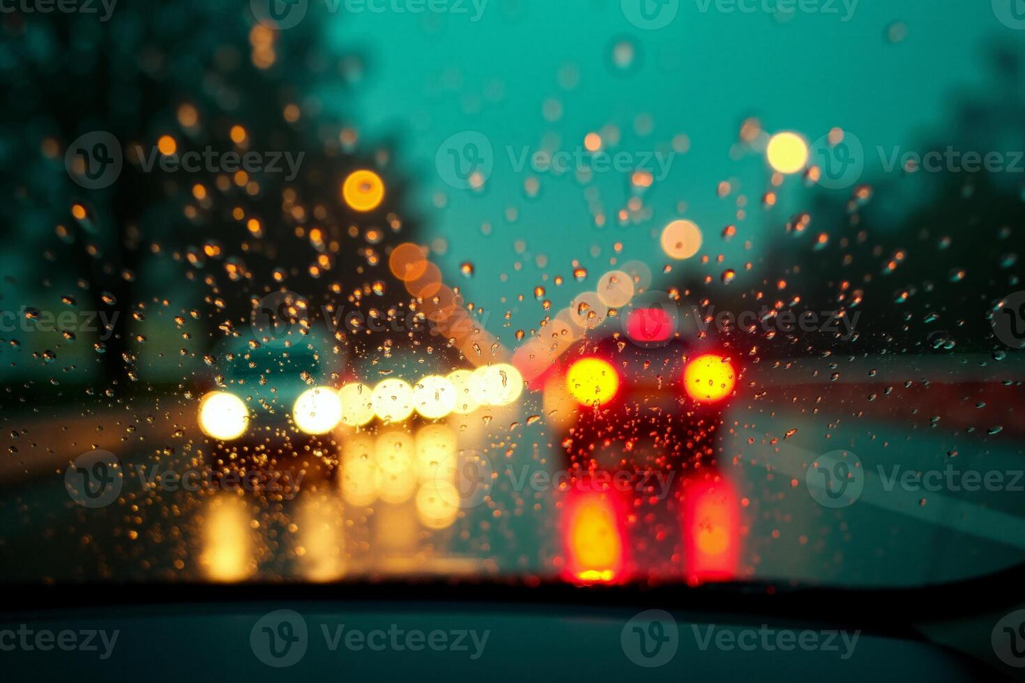 windscreen of car with rain drop water at night photo