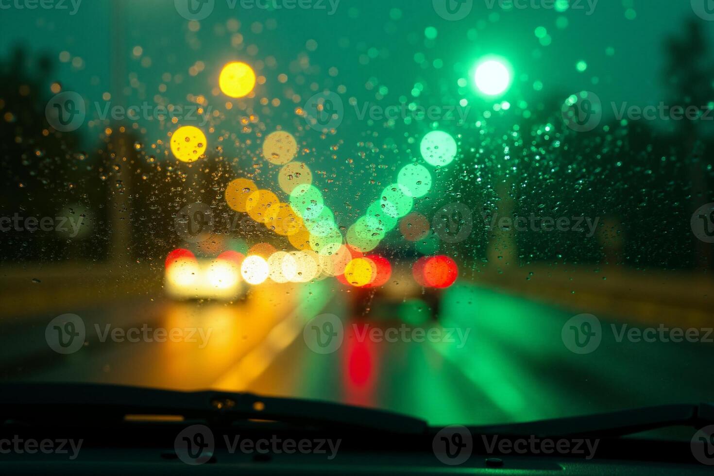 windscreen of car with rain drop water at night photo