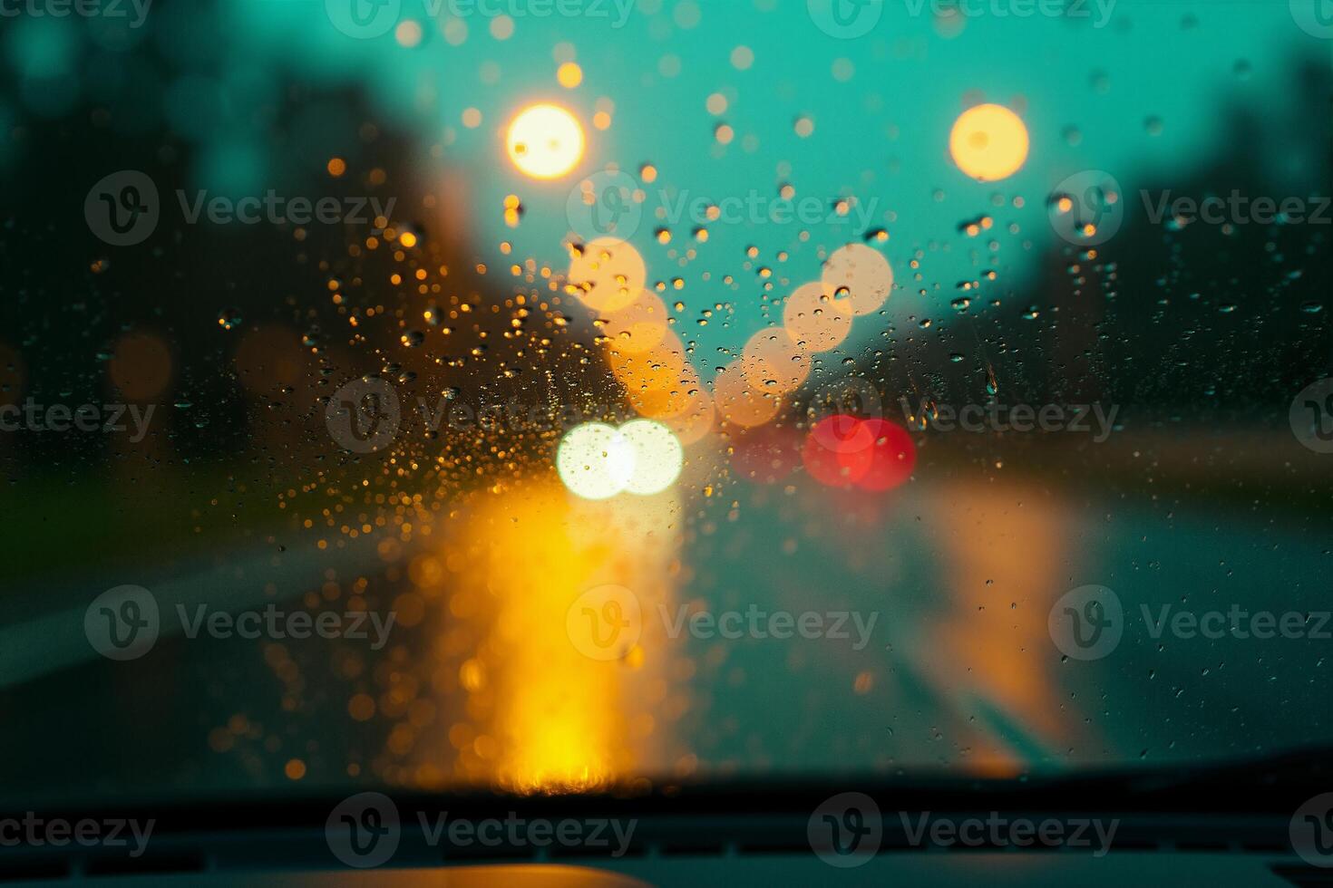 windscreen of car with rain drop water at night photo