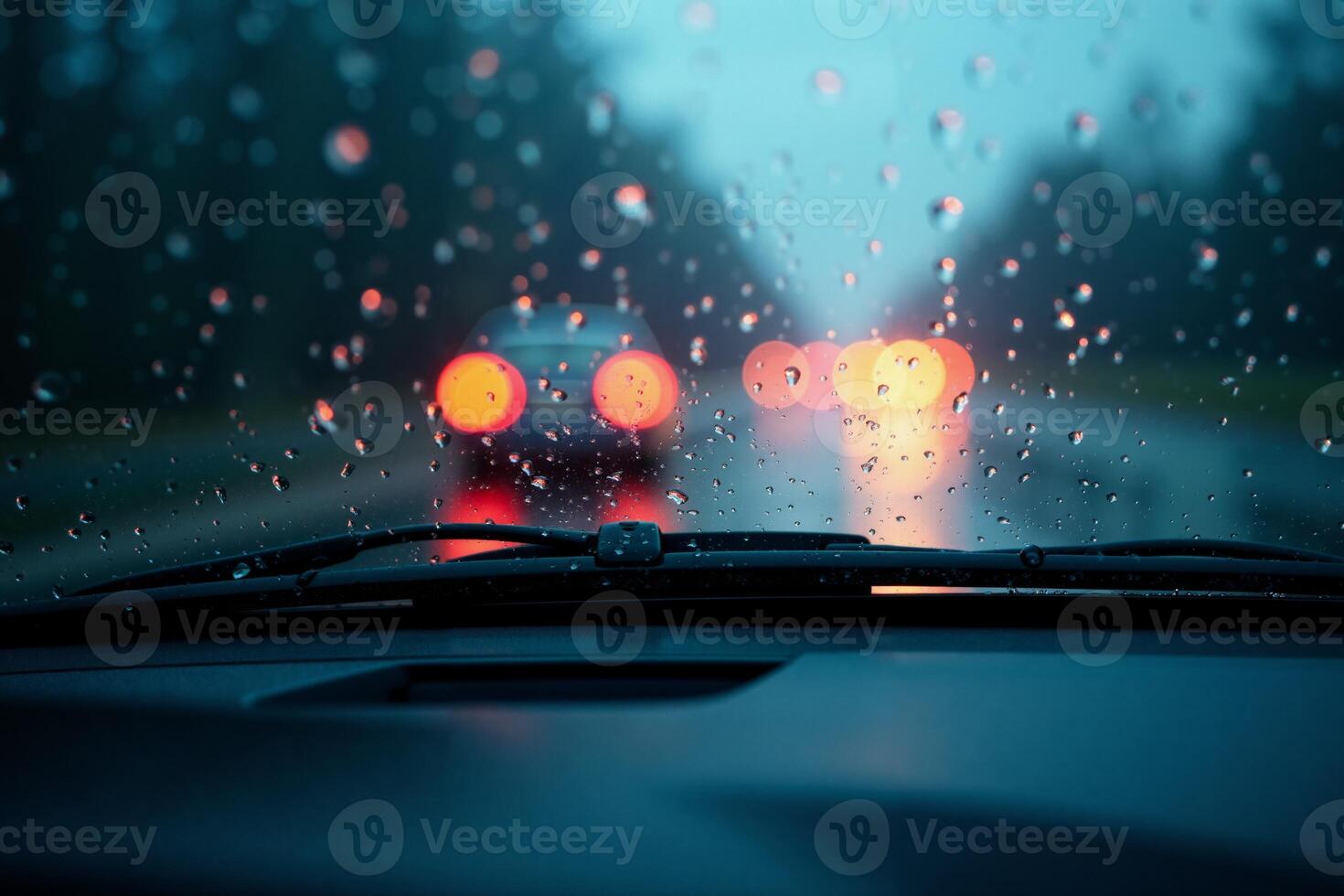 windscreen of car with rain drop water at night photo