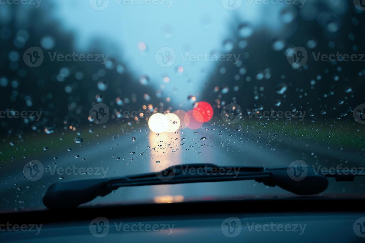 windscreen of car with rain drop water at night photo