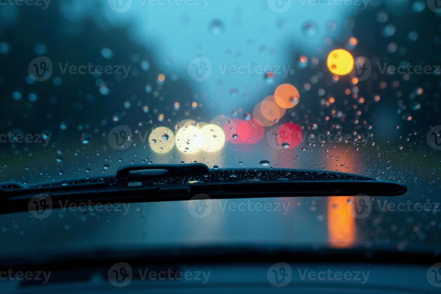 windscreen of car with rain drop water at night photo