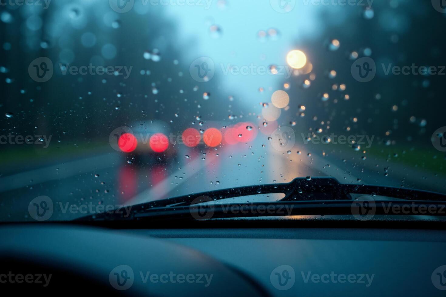windscreen of car with rain drop water at night photo