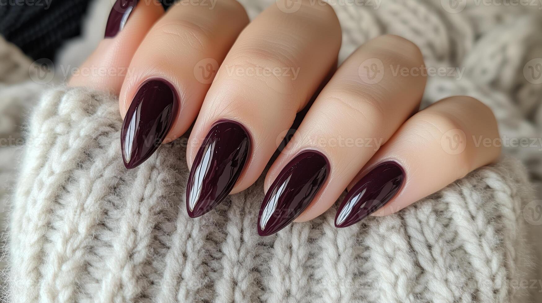 Two hands expertly manicured with a deep purple polish photo