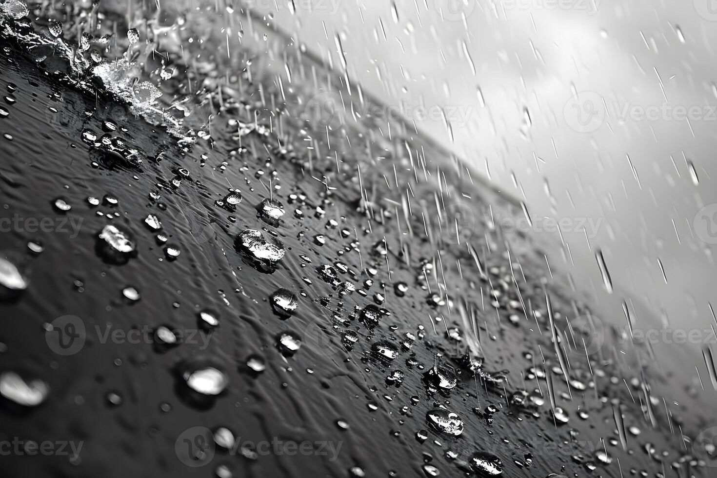 Dynamic Raindrops on a Glass Surface in Black and White for Artistic Design photo