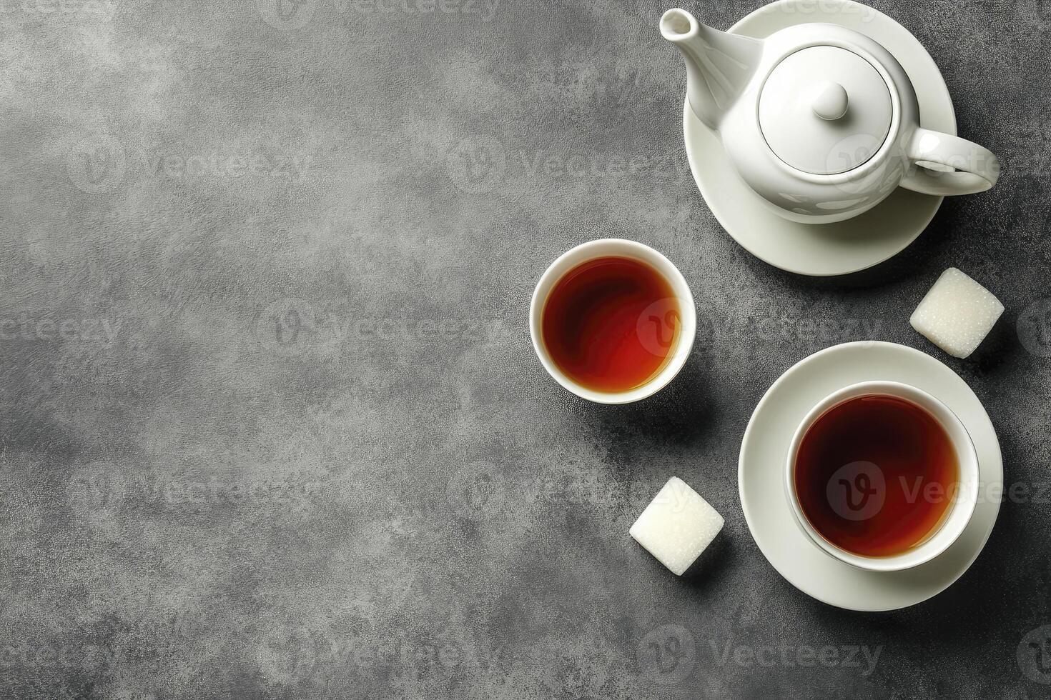 Tea and sugar cubes on a grey background photo