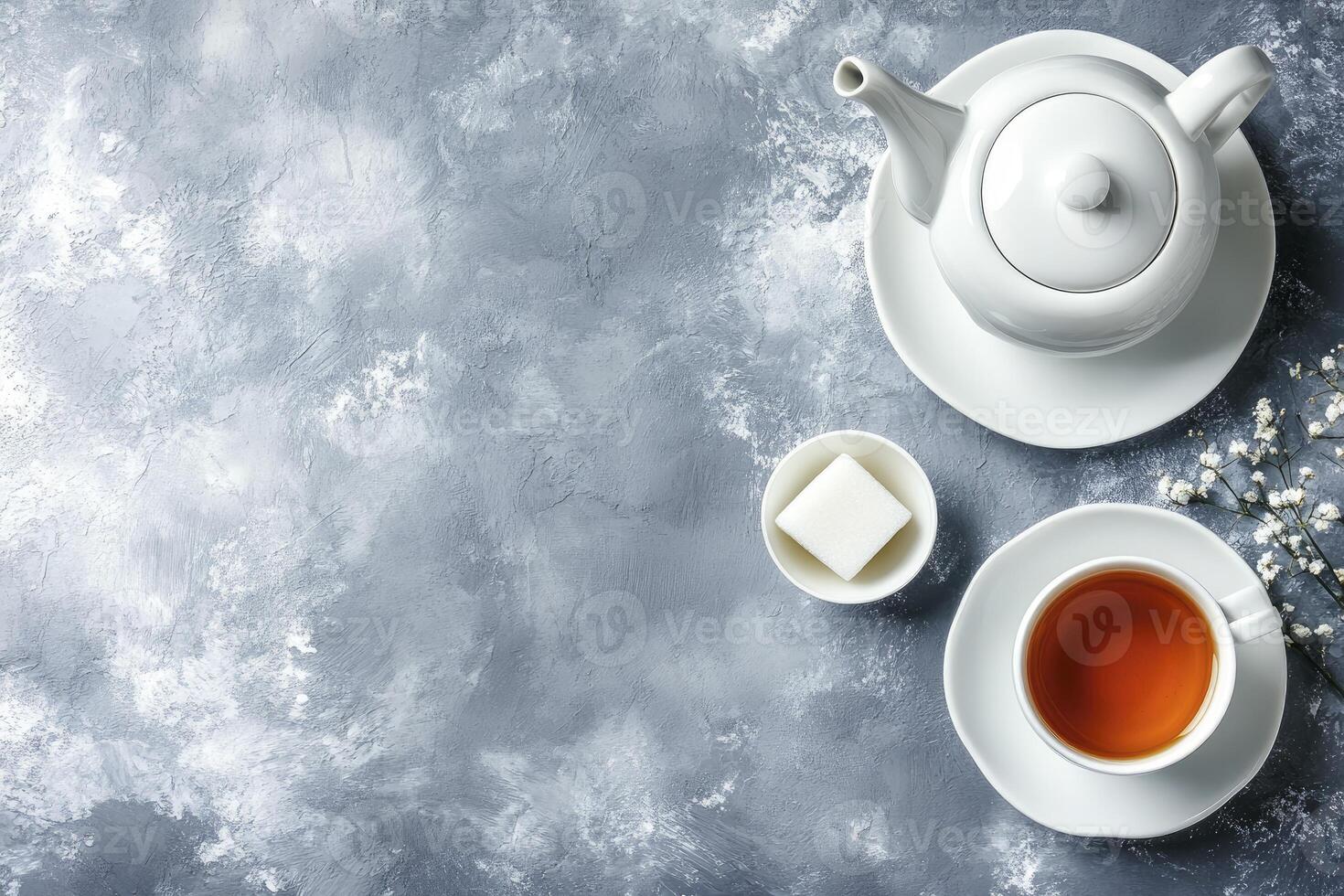 Tea and sugar on a grey background photo