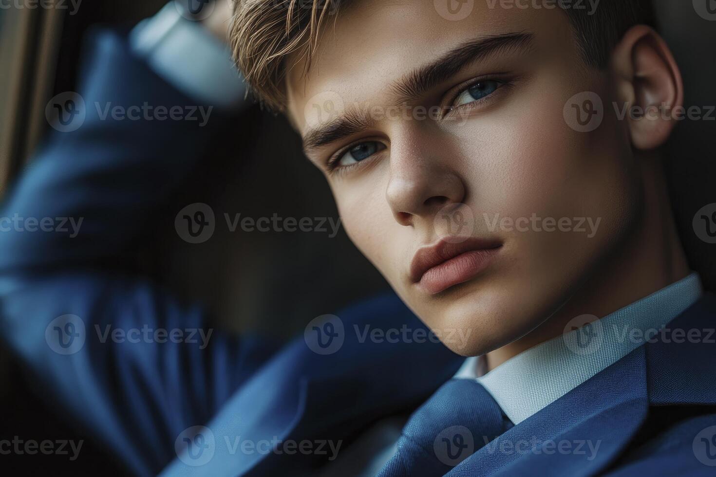 A young man in a blue suit and tie photo