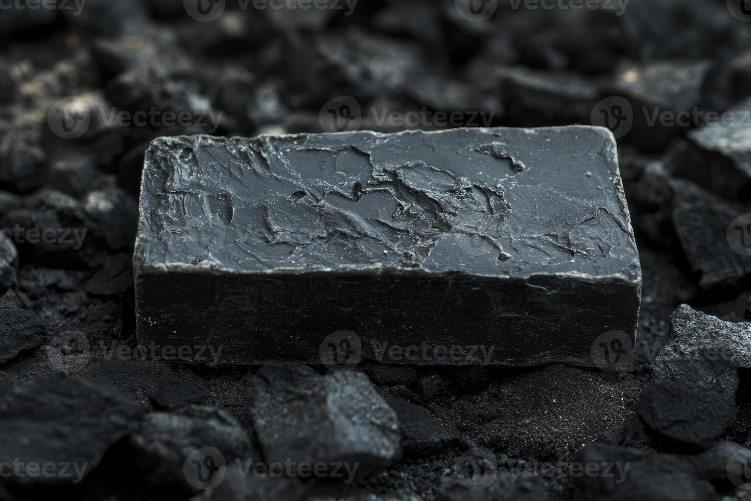 A black soap bar sitting on top of a pile of coal photo