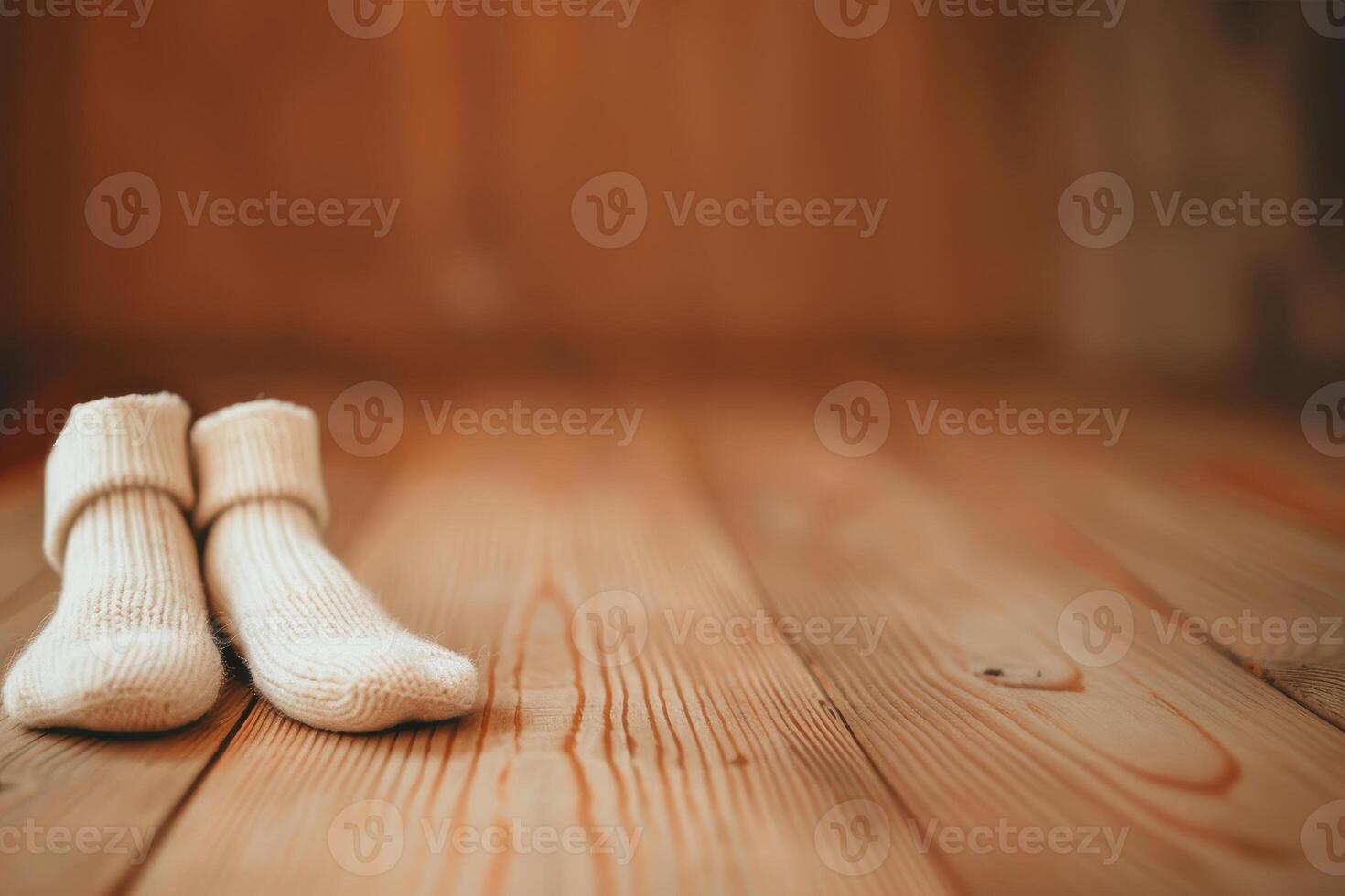 A pair of white socks on a wooden floor photo