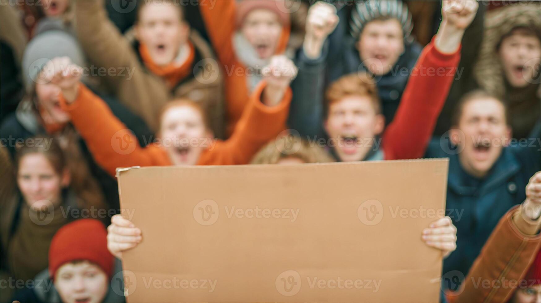 A group of people holding up a sign photo