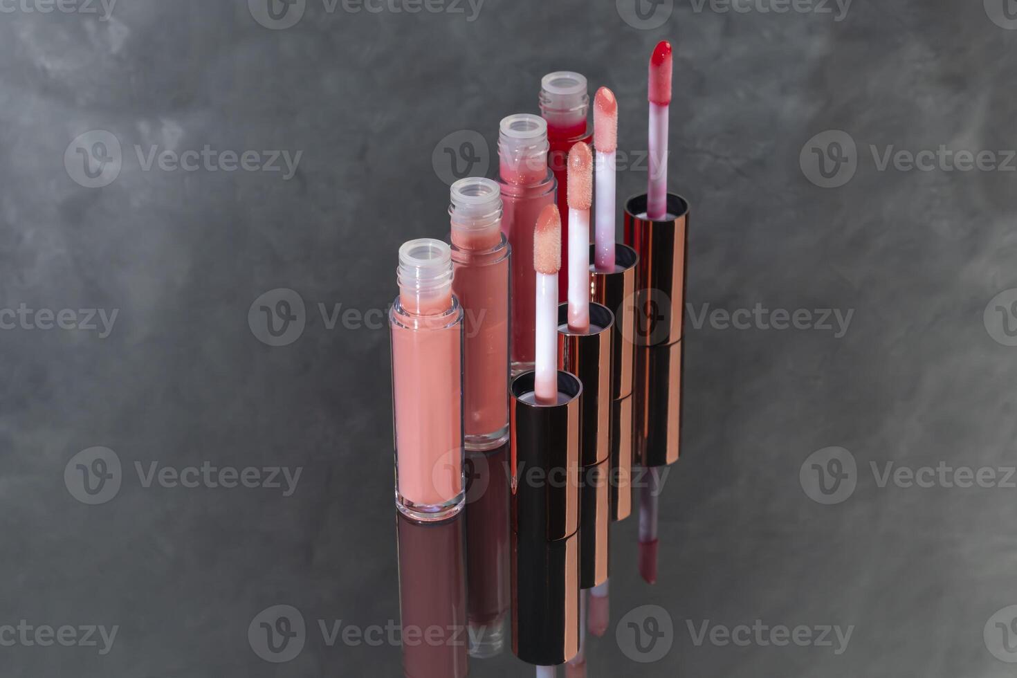 Lip gloss with applicator in light tubes. Cosmetic accessories. photo