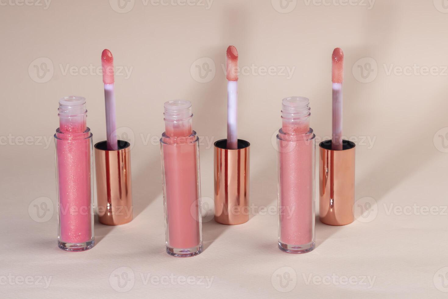 Lip gloss with applicator in light tubes. Cosmetic accessories. photo