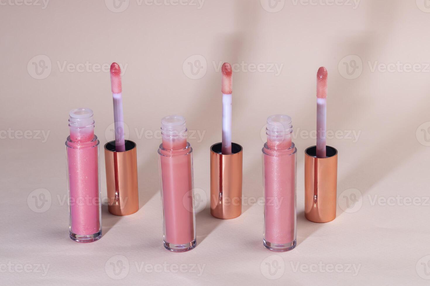 Lip gloss with applicator in light tubes. Cosmetic accessories. photo