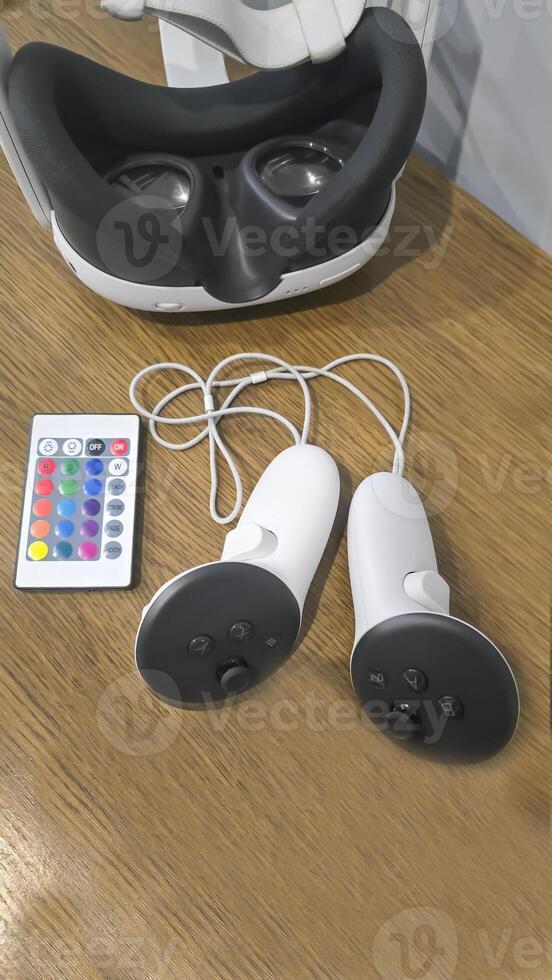 Virtual game set. VR headset. Glasses are on the table next to the control panel photo