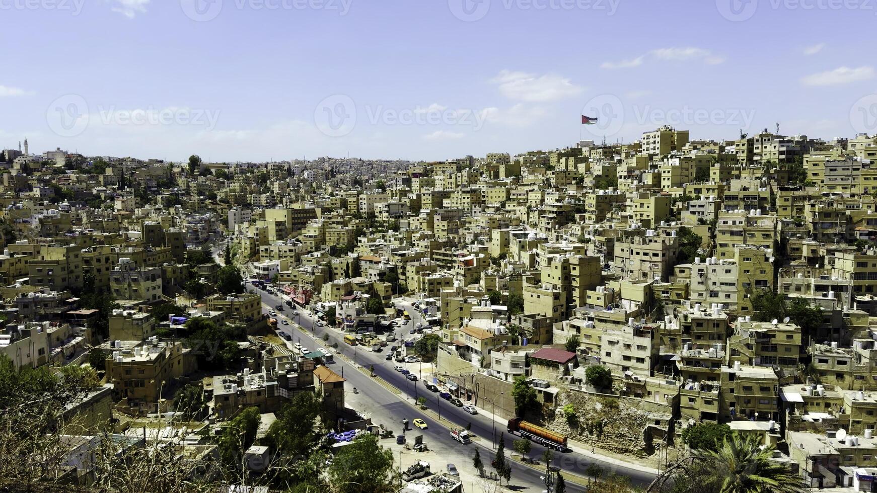 A panoramic view of a vibrant cityscape with rolling hills and unique architecture. Action photo