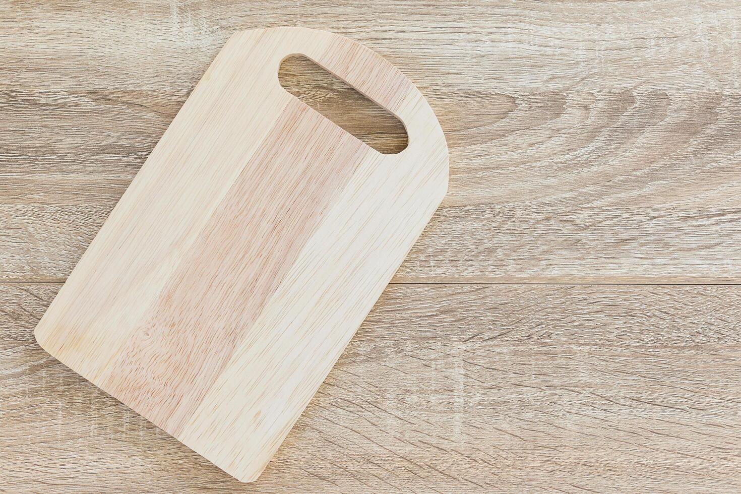 Top view chopping board on wood table photo