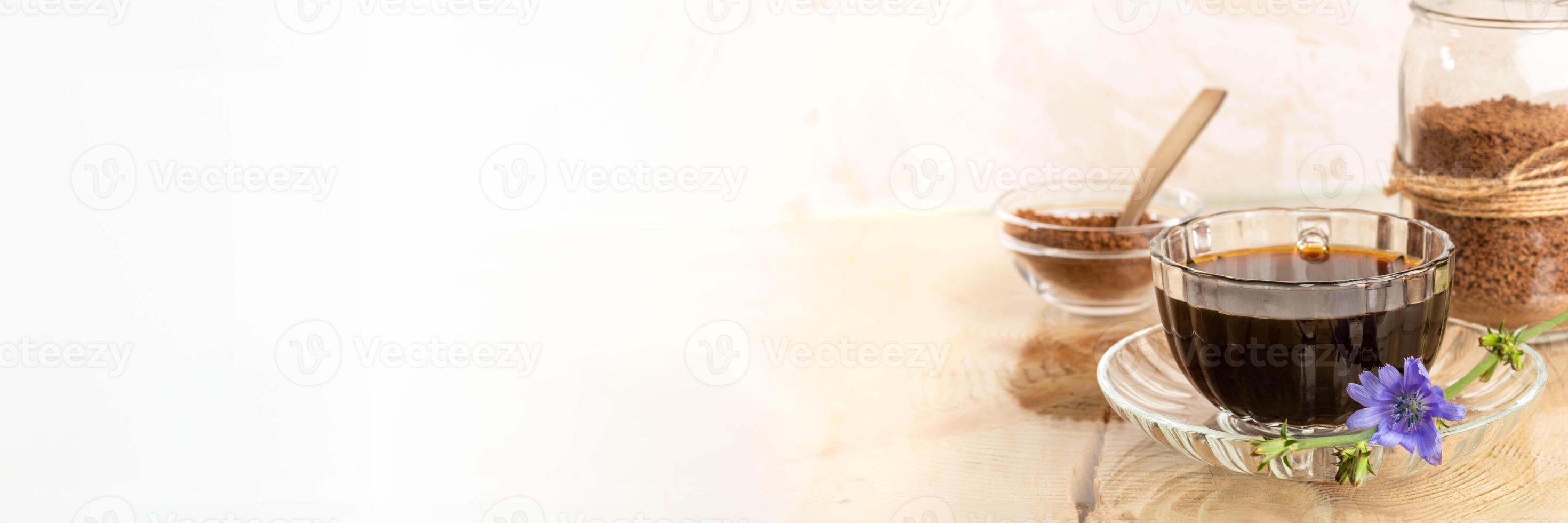 Chicory tea in cup on saucer, granular chicory in bowl and jar, lilac flower on white. Copy space. photo