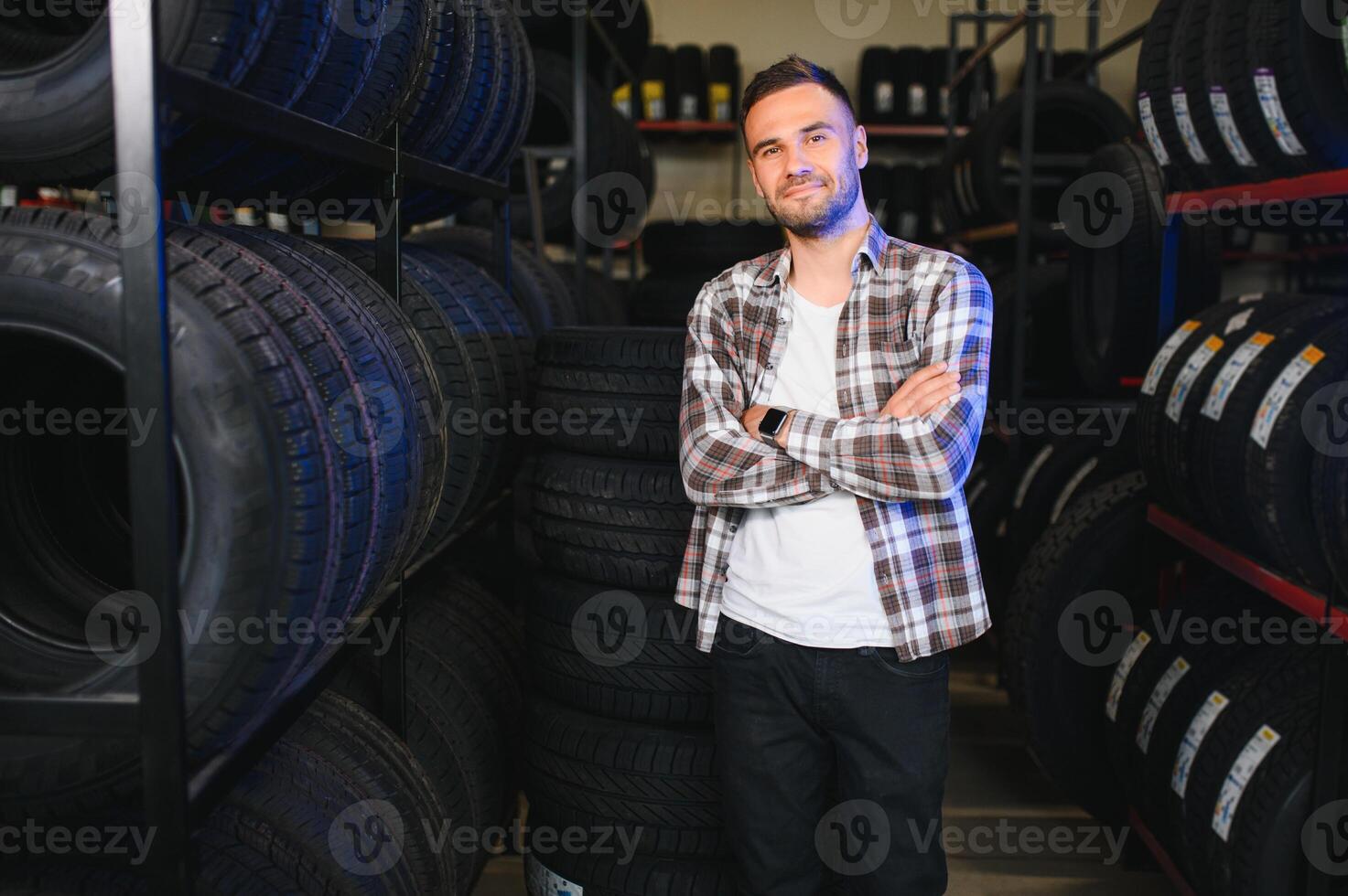 Man chooses winter car tires in the auto shop photo