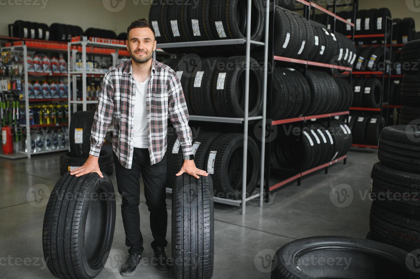 Man chooses winter car tires in the auto shop photo