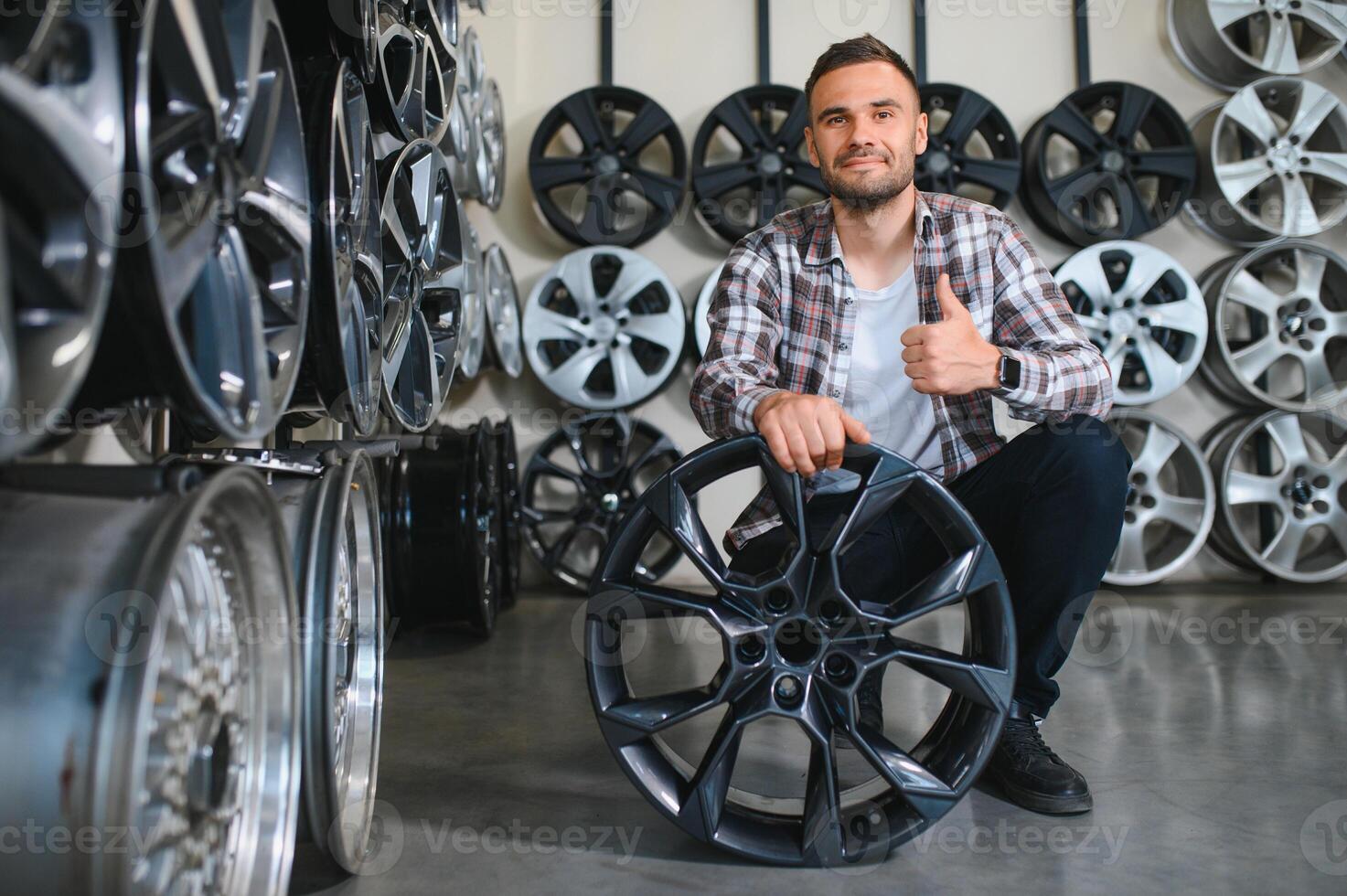 A male customer in a car rim shop photo