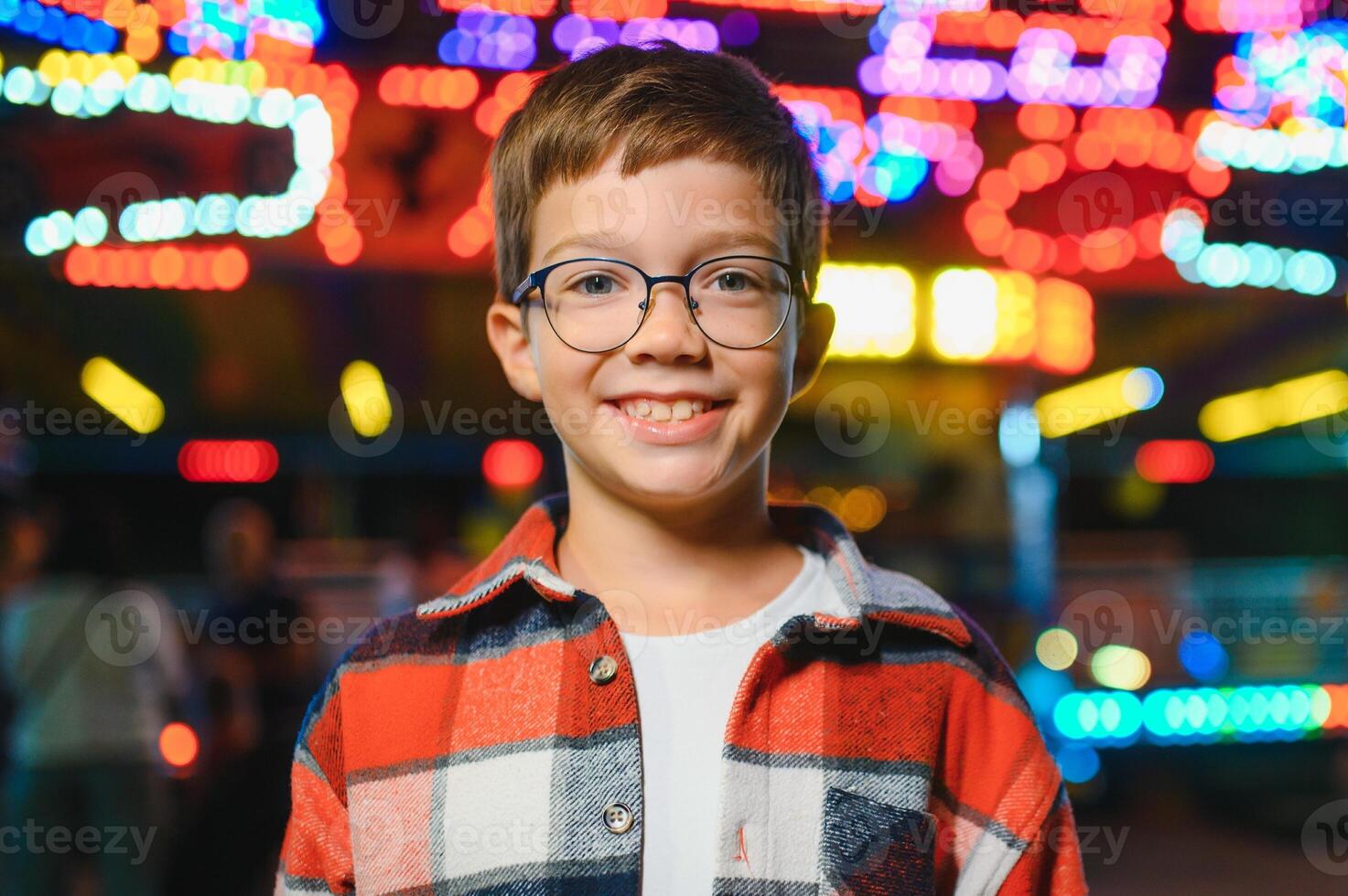 A handsome and happy boy is having fun in the amusement park photo