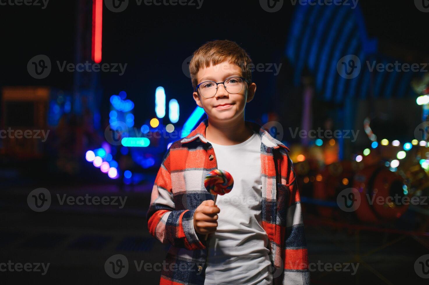 A handsome and happy boy is having fun in the amusement park photo