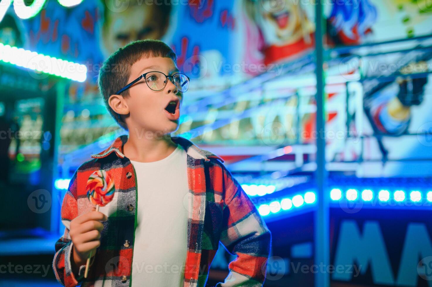 A handsome and happy boy is having fun in the amusement park photo
