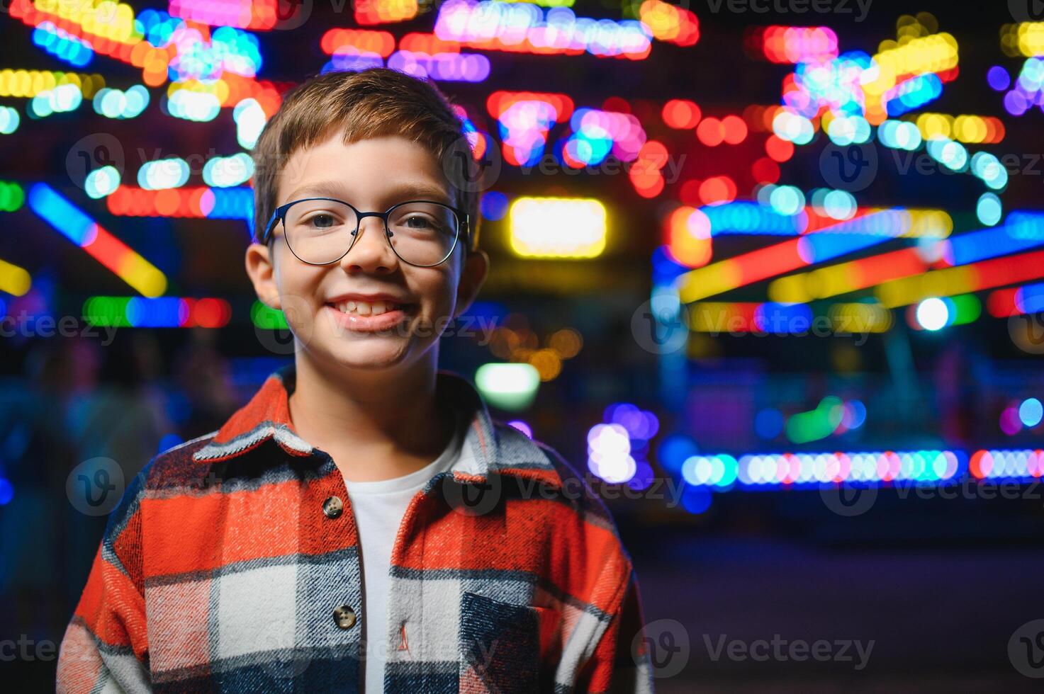 A handsome and happy boy is having fun in the amusement park photo