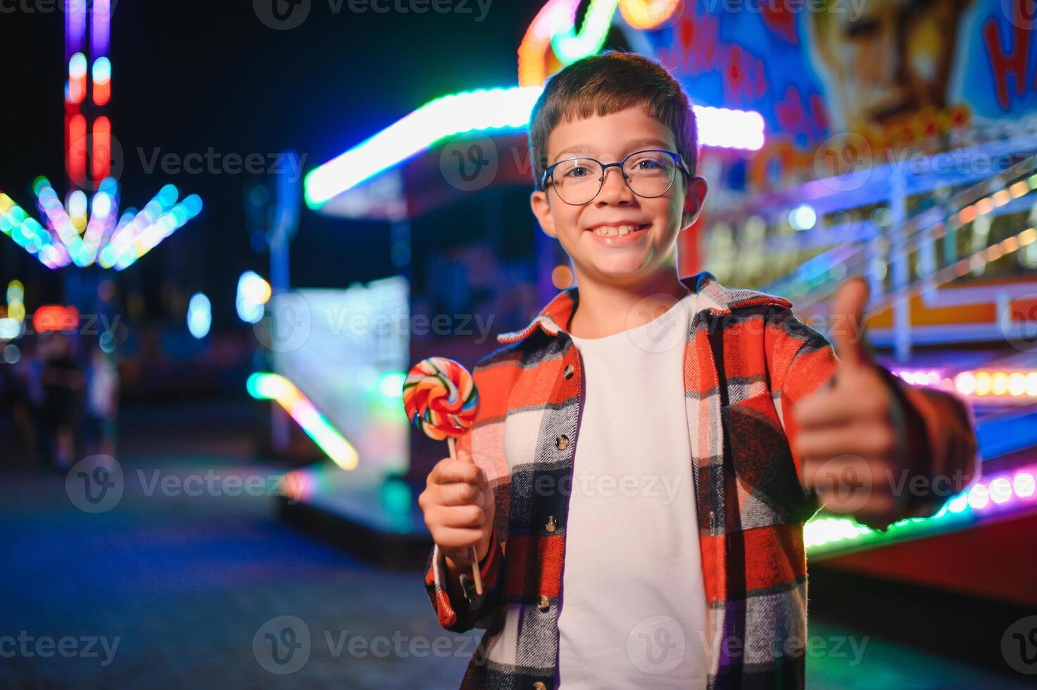 A handsome and happy boy is having fun in the amusement park photo